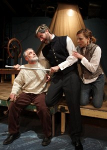 Ahab, Anthony Giampetro, is measured for his new leg by the ship's carpenter, Dave Fiebert, as Pip, the cabin boy, interferes.