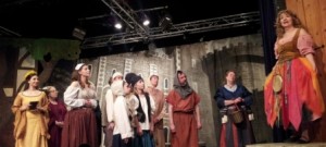 Elsie Maynard (played by Mary Punshon of Broomall, PA) sings “I Have a Song to Sing, O” while Kate (left played by Maria Leonetti of Philadelphia, PA), Phoebe Meryll (third from left played by Paula Gonzalez of Newark, DE) and the tower citizens listen.