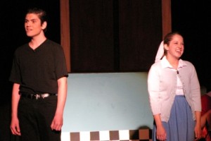 Danny (Alex Papatolis) and Sandy (Sarah Cohn) reminisce over their summer together.